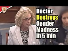 a woman sitting at a table in front of a microphone with the caption doctor destroys genderer madness in 5 minutes