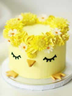 a yellow cake decorated with flowers and birds