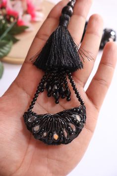 ➤Infuse your Indian garments with our Matt black Tassel Hanging. ➤Product Details: Materials: Beads, pearls, cutdana, crystal Color: Black Usage: Ideal for bridal Indian blouses, dupattas, lehengas, saris, and waist belts Quantity: Pair of 2 tassel latkans ➤➤ Delivery time : 8-14 business days anywhere in the world with standard shipping ➤➤ There may be some difference in color due to lighting and screen settings. Luxury Silver Danglers With Latkans, Traditional Luxury Chandbalis With Latkans, Cheap Chandbalis With Latkans For Wedding, Luxury Chandbalis With Latkans For Women, Cheap Jewelry With Latkans For Diwali, Black Beaded Fringe Tassel Earrings For Festival, Black Beaded Fringe Tassel Earrings For Party, Party Tassel Earrings With Fringe And Round Beads, Black Beaded Tassel Earrings