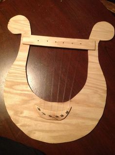 a wooden instrument with a bear design on it