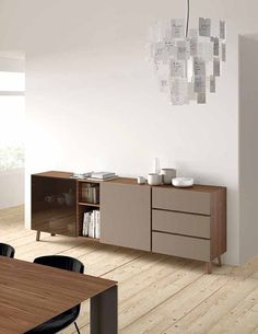 an empty room with a table, chairs and a bookcase on the sideboard