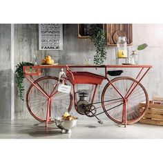 an old fashioned bicycle is sitting in front of a table