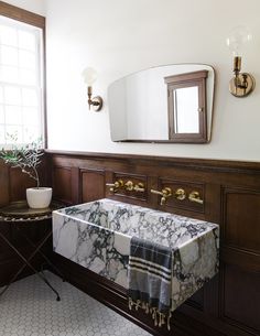 a bathroom with a marble sink and mirror