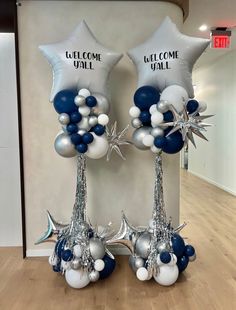 two silver and blue balloons with star decorations