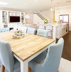 a dining room table with blue chairs around it