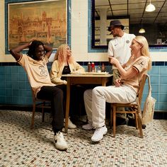 three people sitting at a table in a restaurant