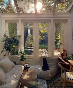 the sun shines through the glass roof in this living room