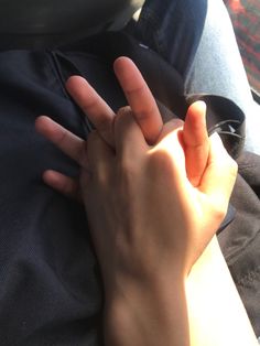 a person is holding their hand up to the camera with both hands on top of each other