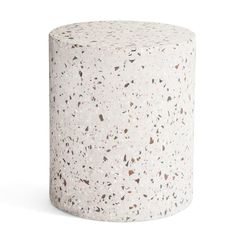 a white and brown speckled stool on a white background