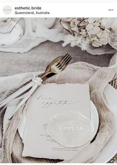 a place setting with silverware and napkins