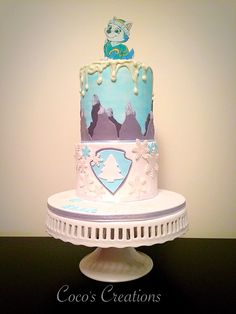 a three tiered cake with frosting and decorations on the top is sitting on a pedestal