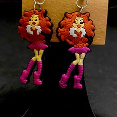 two pairs of earrings with cartoon characters on them