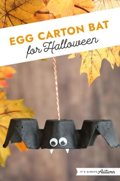 an egg carton bat for halloween hanging from a string