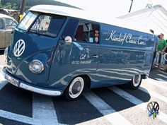 an old vw bus is parked in the parking lot