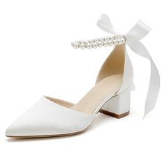 a pair of white shoes with pearls on the heel