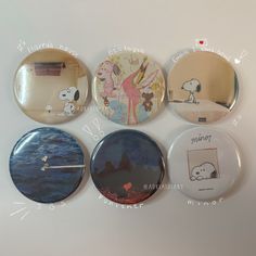 four buttons with pictures of cartoon characters on them, all in different colors and sizes