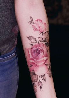 a woman with a rose tattoo on her arm