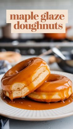 two glazed doughnuts on a plate with caramel sauce drizzled over them