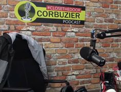 a brick wall with a sign and microphone in front of it that says corbuzier