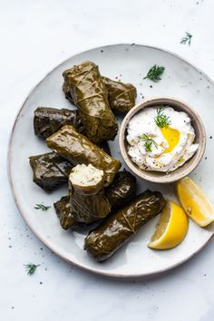 stuffed grape leaves with yogurt and lemon wedges