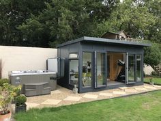 a backyard with a hot tub and exercise equipment