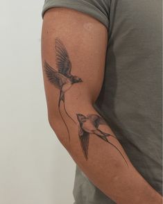 a man with a bird tattoo on his arm