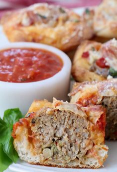 meatball muffins on a plate with tomato sauce