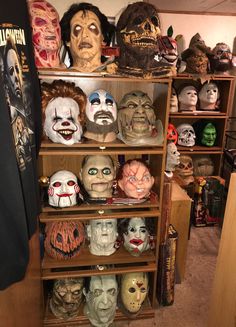 a shelf filled with lots of halloween masks