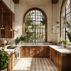 a large kitchen with an arched window and tiled floor, along with potted plants