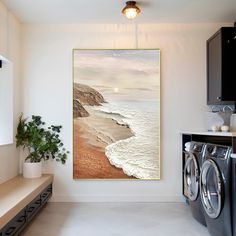 a washer and dryer in a room with a painting on the wall