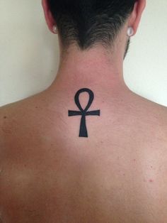 an egyptian symbol on the back of a man's neck