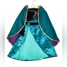 Disney Parks Frozen 2 Queen Anna Dress & Cape Youth Costume Size 11/12 New New With Tags From A Smoke Free Environment 2 Piece Set Includes: Dress And Cape Satin Dress With Velvet Overlay On Bodice Glittery Artwork Along Sleeves Decorative Velvet Belt With Badge Detail Glittery Artwork At Front And Back Slit On Skirt Reveals Contrasting Chiffon Underlay Stretchy Back For Comfortable Fit Satin Cape With Glittery Artwork And Bronze-Toned Piping Contrast Satin Lining Dress - Shell: 100% Polyester, Elsa Costume For Kids, Anna Outfit, Anna Coronation Dress, Blue Satin Skirt, Sven Frozen, Anna Coronation, Frozen Halloween, Anna Costume, Coronation Dress