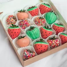 a box filled with chocolate covered strawberries and sprinkles