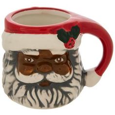 a ceramic mug with a santa claus face on it