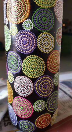 a colorful vase is sitting on the table