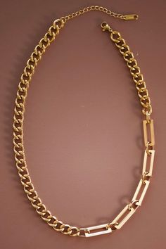 This is a simple but chunky chained necklace. The gold necklace is linked with rectangled links. Length: 7 1/2” Everyday Gold-tone Chain Necklace, Chic Rectangular Adjustable Chain Necklace, Rectangular Metal Chain Necklace With Adjustable Chain, Rectangular Chunky Chain Metal Necklace, Trendy Rectangular Gold Chain Necklaces, Trendy Rectangular Gold Chain Necklace, Chic Metal Chain Necklace With Rectangular Links, Chic Rectangular Links Chain Necklace, Rectangular Gold Chain Metal Necklace