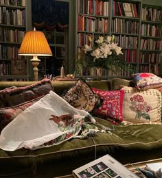 a living room filled with lots of books and furniture