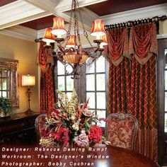 a dining room table with chairs and a chandelier