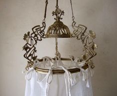 a bell hanging from the ceiling with bells attached to it's sides and other decorations around it