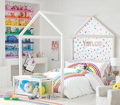 a child's bedroom decorated in white and rainbow colors