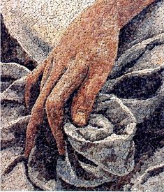 a painting of a person's hand on top of a pile of rocks and cloth