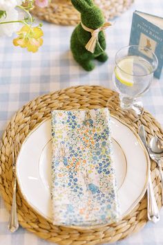 a table set with place settings, napkins and silverware for an easter brunch