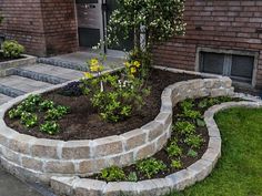 an outdoor garden area with steps and flowers in the center, surrounded by brick walls