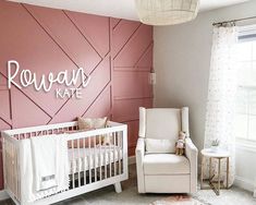 a baby's room with pink walls and white furniture