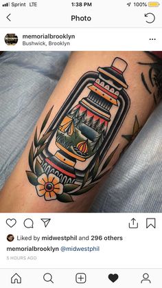 a person with a tattoo on their arm has a jar full of things in it