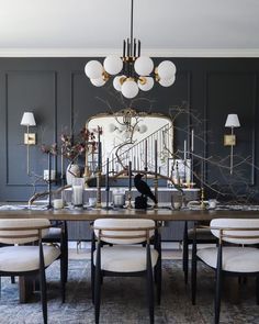 a dining room table with chairs and a chandelier