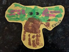 a child's hand and foot print made to look like an elephant with green hands