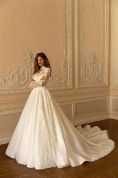 a woman in a wedding dress posing for the camera with her hands on her hips