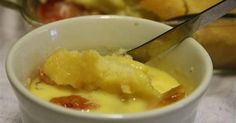 a close up of a bowl of food with a knife in it