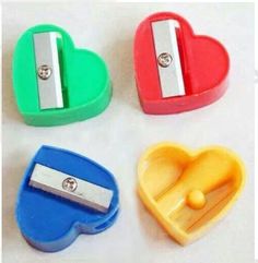 four heart shaped magnets with metal clips on them